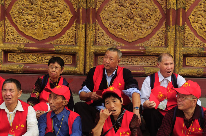 Row of People in Red, Ornate Door, Beijing