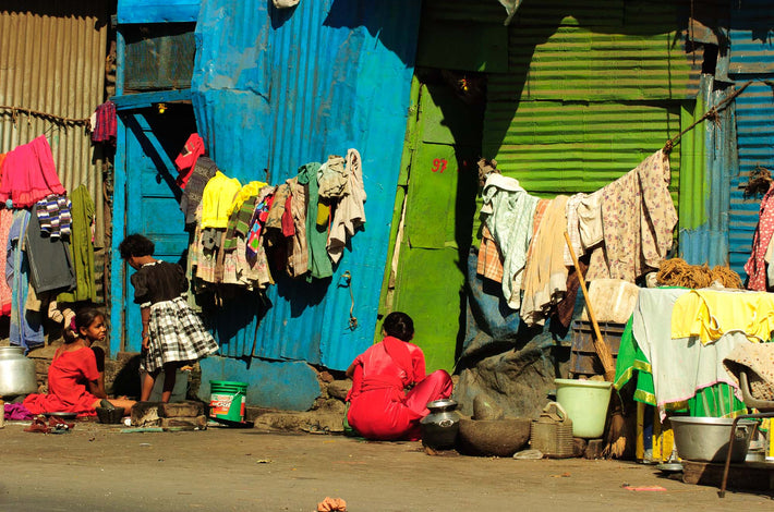 Two in Red Sitting, One Standing in Plaid Skirt, Mumbai