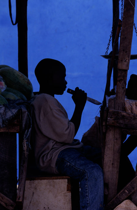 Boy with Knife Silhouette Against Blue, Jamaica